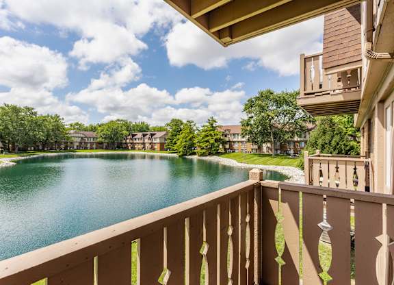 A view from a balcony overlooking a lake