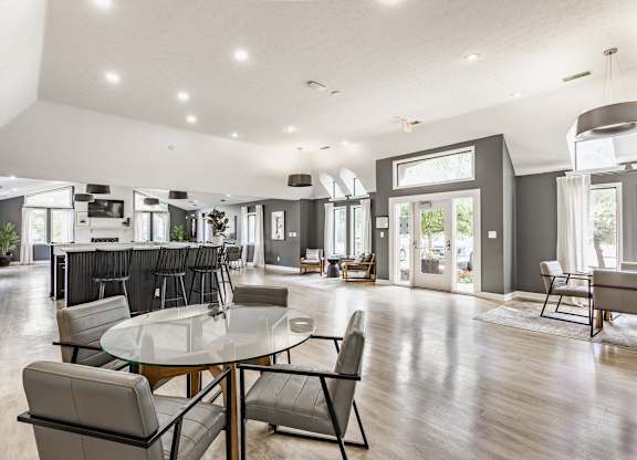 A modern dining room with a glass table and chairs