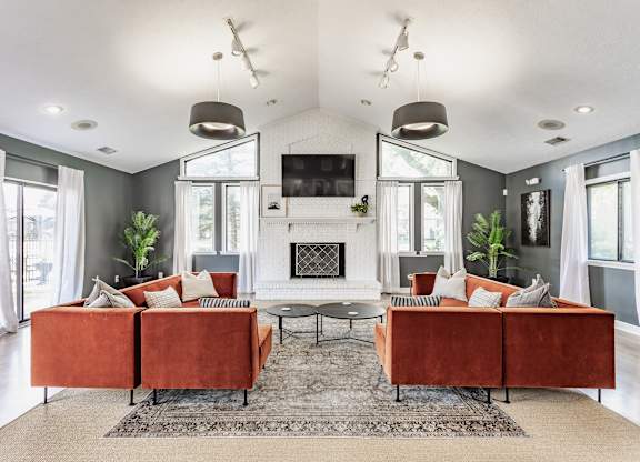 A living room with a fireplace and a television.