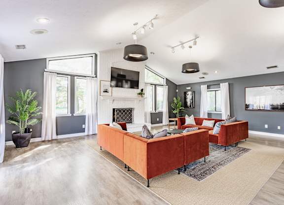 A modern living room with a fireplace and a large couch