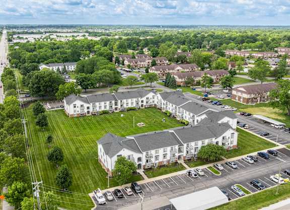 A large white building with a green lawn in front of it.