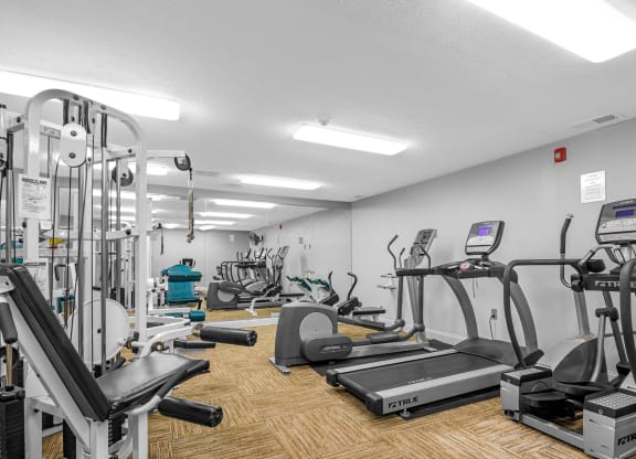 a gym with various cardio equipment and weights on the floor at Bay Pointe Apartments, Lafayette, IN, 47909