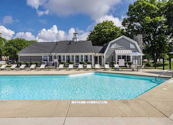 A pool with a building behind it.
