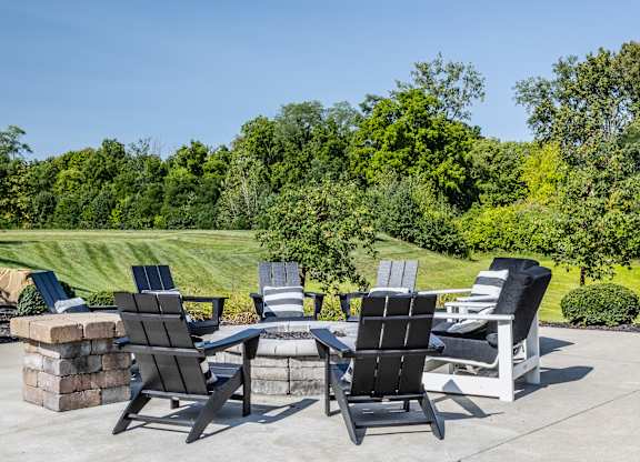 A set of four chairs are arranged on a patio.