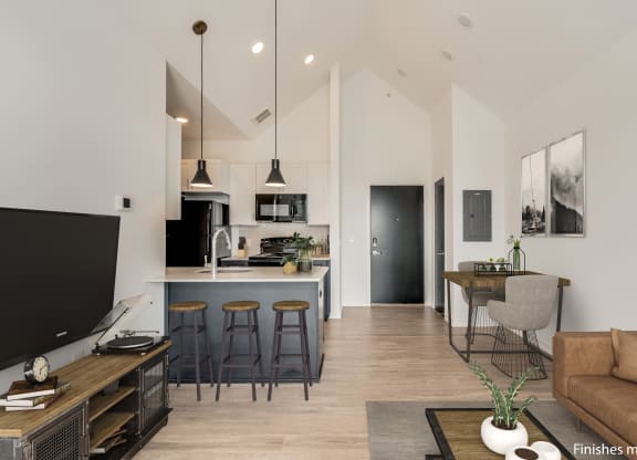 a kitchen and living room with white walls and wood flooring  at Uptown Square Apartments, Troy