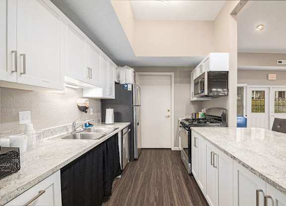 a clubhouse kitchen with white cabinets at Black Sand Apartment Homes, Nebraska