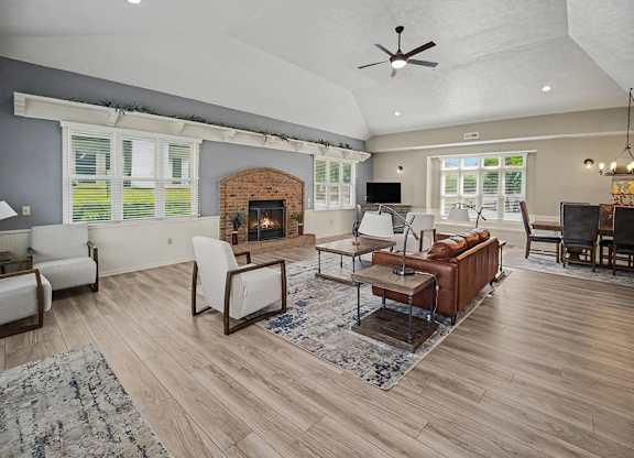 Open living and dining room with brick fireplace at Black Sand Apartments Homes, Lincoln