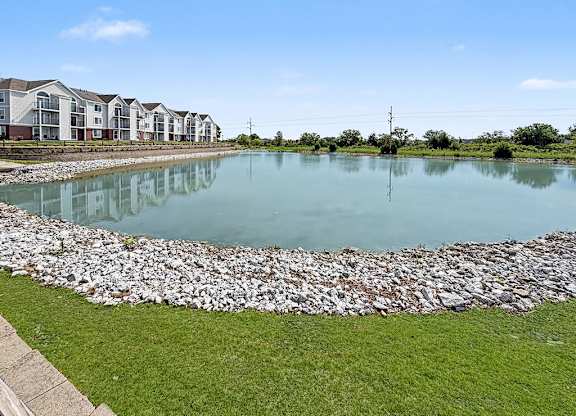 Retention pond with rock edging and apartment views at Black Sand Apartments Homes, Lincoln, NE