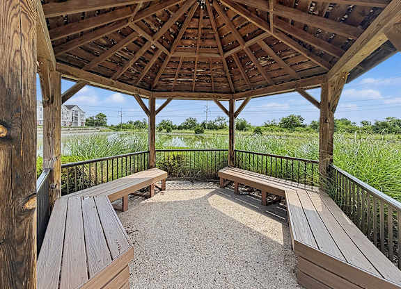 Wooden gazebo overlooking wetland with benches at Black Sand Apartments Homes, Lincoln, 68504