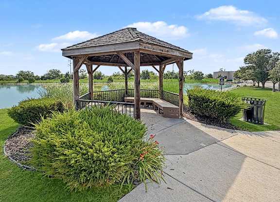 Wooden gazebo overlooking pond with walking path at Black Sand Apartments Homes, Lincoln, Nebraska