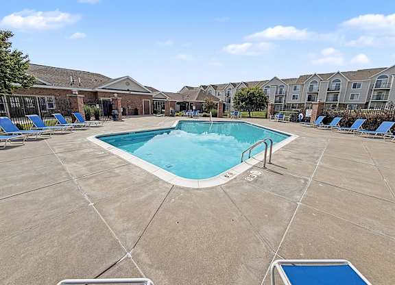 Outdoor pool area with sundeck and lounge seating at Black Sand Apartments Homes, Lincoln, NE 68504