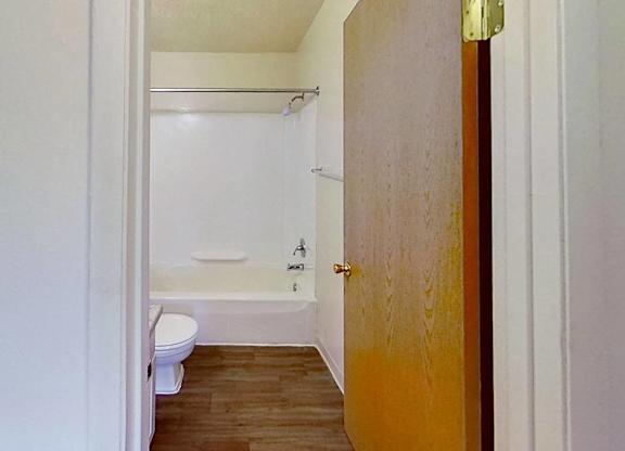 A bathroom with a toilet, tub, and sink at Briarwood Apartments in Benton Harbor, MI