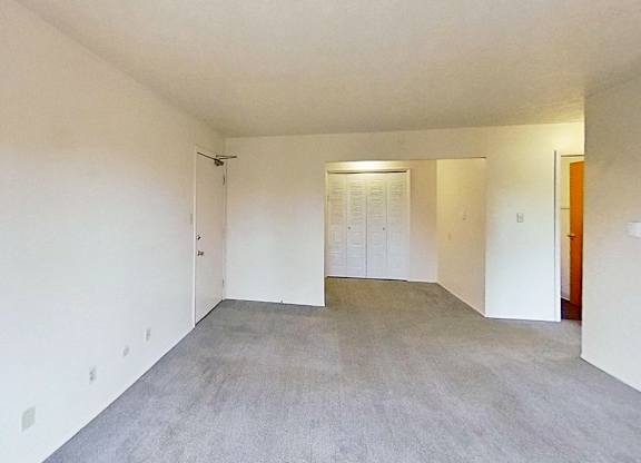 A large empty living and dining room at Briarwood Apartments in Benton Harbor, MI