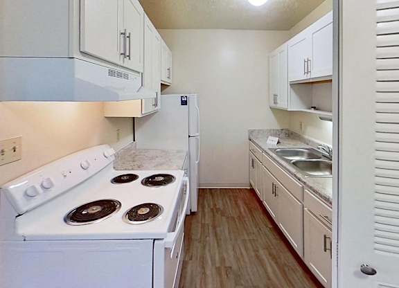 An upgraded kitchen with white cabinets at Briarwood Apartments in Benton Harbor, MI