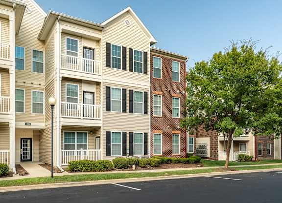 Apartment building with a tree in front of it