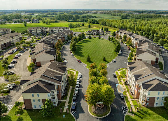 A bird's eye view of a residential area with houses and cars