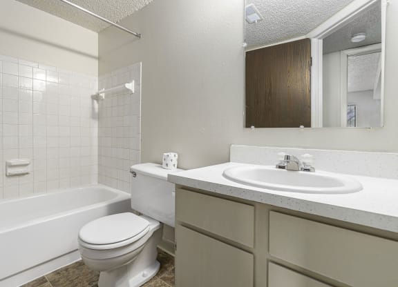 a bathroom with a sink toilet and a bath tub at Briarwood Apartments, Benton Harbor, MI