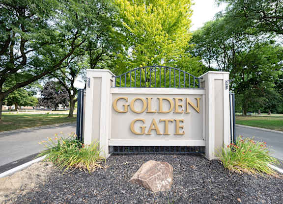 A sign that says "Golden Gate" is in front of a gate.