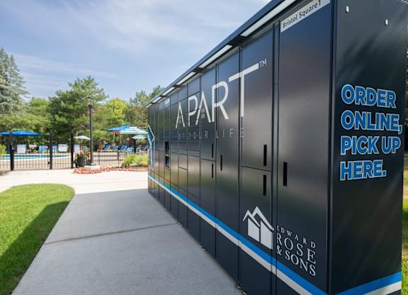 A black and blue building with a sign that says "Apartment Bring Life".