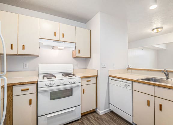 a two bedroom kitchen with white appliances  at Black Sand Apartment Homes, Lincoln, NE
