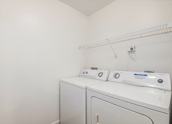 a laundry room with a full size washer and dryer  at Black Sand Apartment Homes, Nebraska