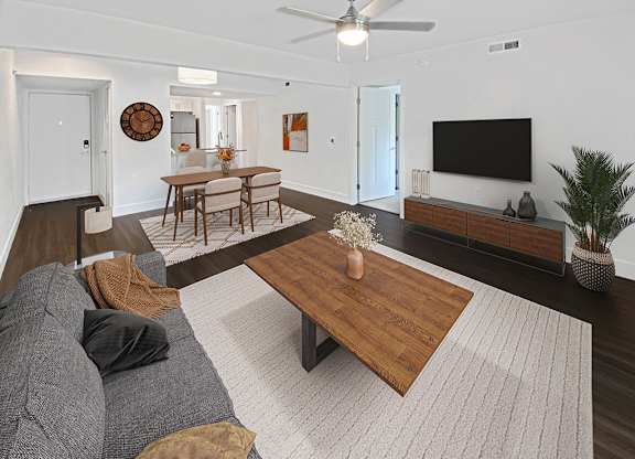 a living room with a ceiling fan and hard surface flooring at Byron Lakes Apartments in Byron Center, MI