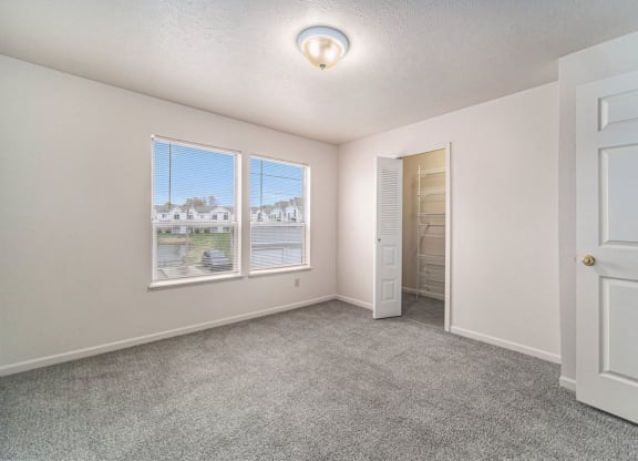 Bedroom with Large Closet and Multiple Windows at Canal 2 Apartments in Lansing, MI
