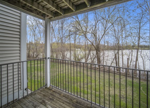 the view from the balcony of an apartment overlooking a pond at Canal 2 Apartments in Lansing, MI