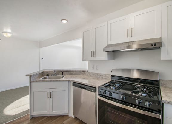 renovated kitchen with white cabinets and stainless steel appliances at Canal 2 Apartments, Lansing, Michigan