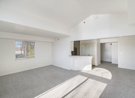 living room with cathedral ceiling and kitchen of an apartment at Canal 2 Apartments, Lansing, Michigan