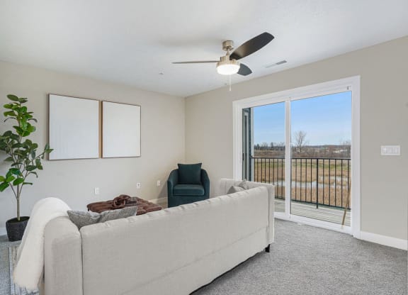 Living Room Leads To Private Balcony at Meadowbrooke Apartment Homes in Kentwood, MI 49512