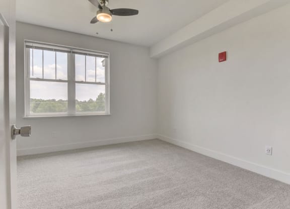 a bedroom with a ceiling fan in at Chase Creek Apartment Homes, Alabama