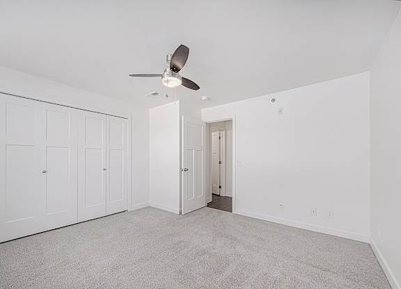 A bedroom with a ceiling fan and carpeted floor at Chase Creek Apartment Homes, Huntsville, AL, 35811