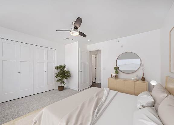 A bedroom with a bed, dresser, mirror, and a ceiling fan at Chase Creek Apartment Homes, Huntsville, AL, 35811