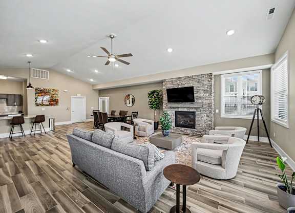 A community building with a grey couch and a fireplace at Chase Creek Apartment Homes, Huntsville, AL, 35811