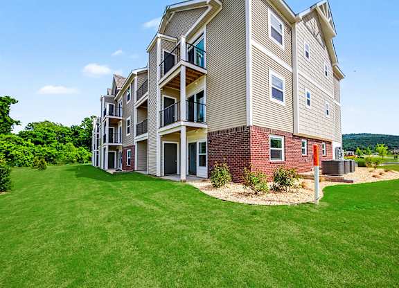 The back of an apartment building with balconies and patios at Chase Creek Apartment Homes, Huntsville, AL, 35811