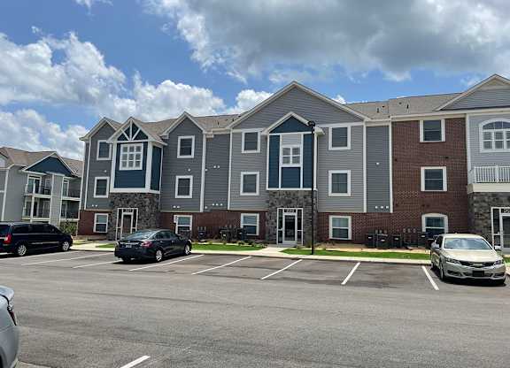 An exterior building with a parking lot in front at Chase Creek Apartment Homes, Huntsville, 35811