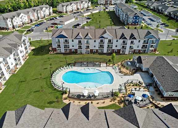 A large apartment complex with a swimming pool in the middle at Chase Creek Apartment Homes, Huntsville, 35811