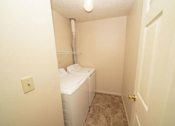 Laundry room with washer and dryer in it at Canal Club Apartments, Lansing, MI, 48917
