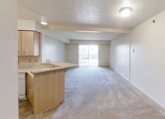 a living room and dining room leading to a kitchen at Colonial Pointe at Fairview Apartments, Bellevue, Nebraska