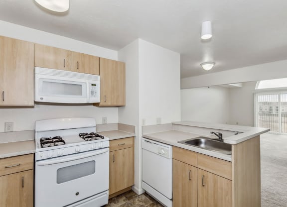 Two bedroom kitchen with a stove microwave and dishwasher at Colonial Pointe at Fairview Apartments, Bellevue, 68123