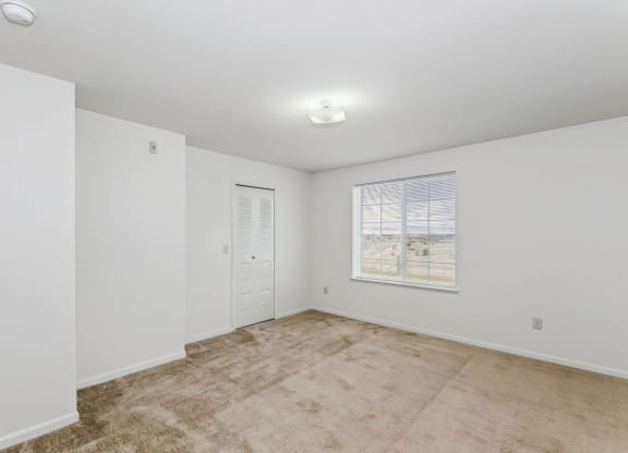 Bedroom with closet and a window at Colonial Pointe at Fairview Apartments, Bellevue, Nebraska