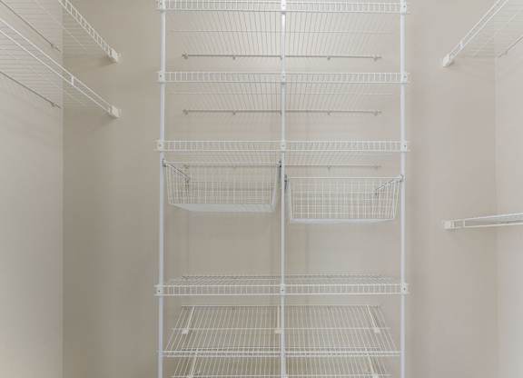A walk-in closet with wardrobe organizers at Colonial Pointe at Fairview Apartments, Bellevue, 68123