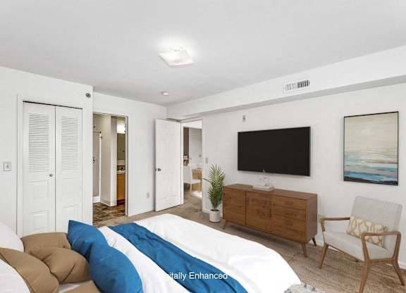 A bedroom with a walk in closet and an attached bathroom at Colonial Pointe at Fairview Apartments, Bellevue, Nebraska