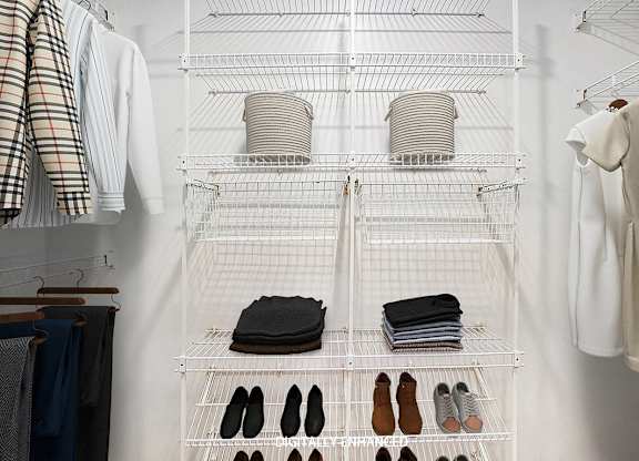 A walk in closet with wardrobe organizers at Colonial Pointe at Fairview Apartments, Bellevue, Nebraska