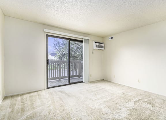 Spacious Living Room Leads To Private Balcony at Concord Place Apartments in Kalamazoo, Michigan 49009
