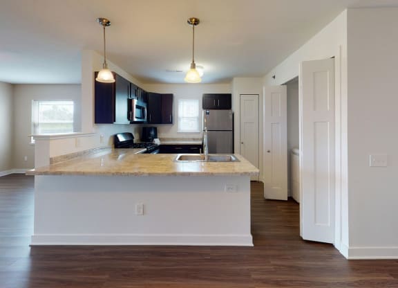 End style kitchen and living area at Copper Creek Apartment Homes in KS 67101