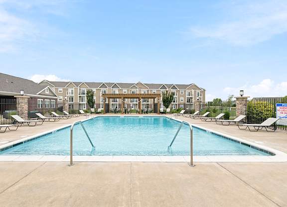 Resort style pool with lounge chairs and pergola at Copper Creek Homes Apartments, Kansas, 67101