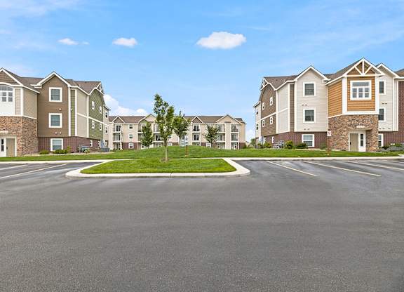 Residential community street view with center median at Copper Creek Homes Apartments, Maize, Kansas