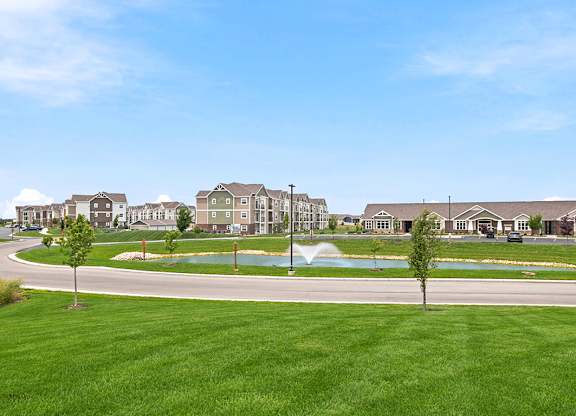 Apartment community with pond and fountain at Copper Creek Homes Apartments, Maize, KS 67101